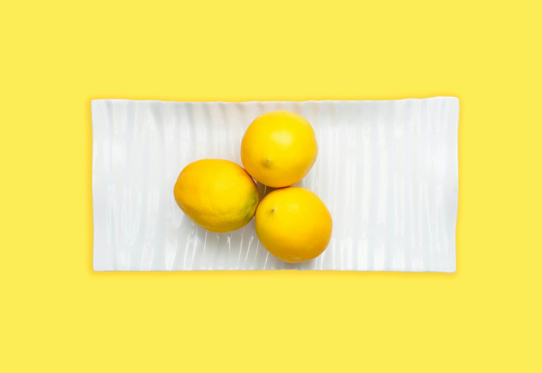 Two fresh lemons held in cupped hands symbolizing natural intimacy and self-care