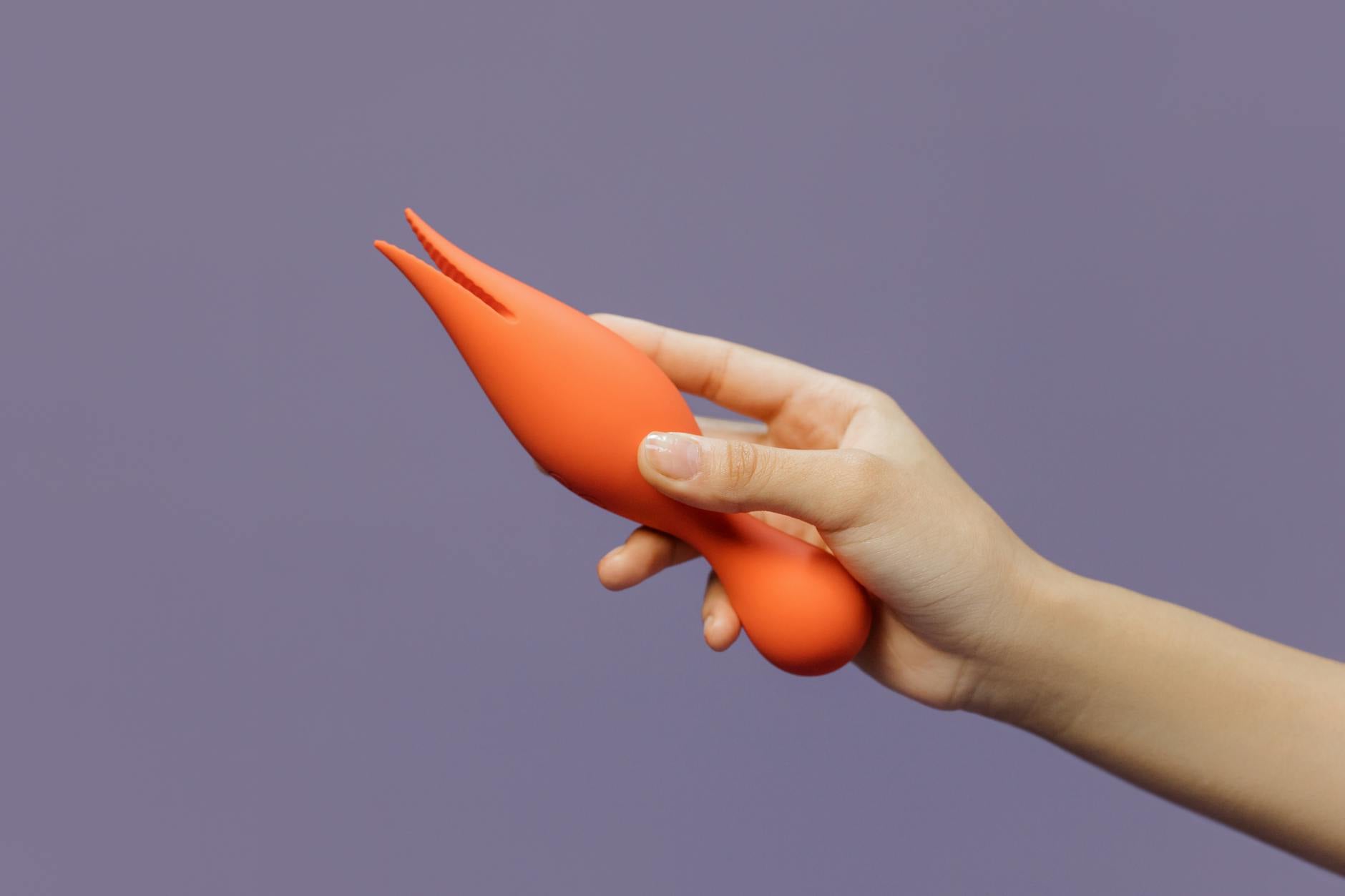 Hands holding a modern vibrator, symbolizing reconnection and intimate comfort