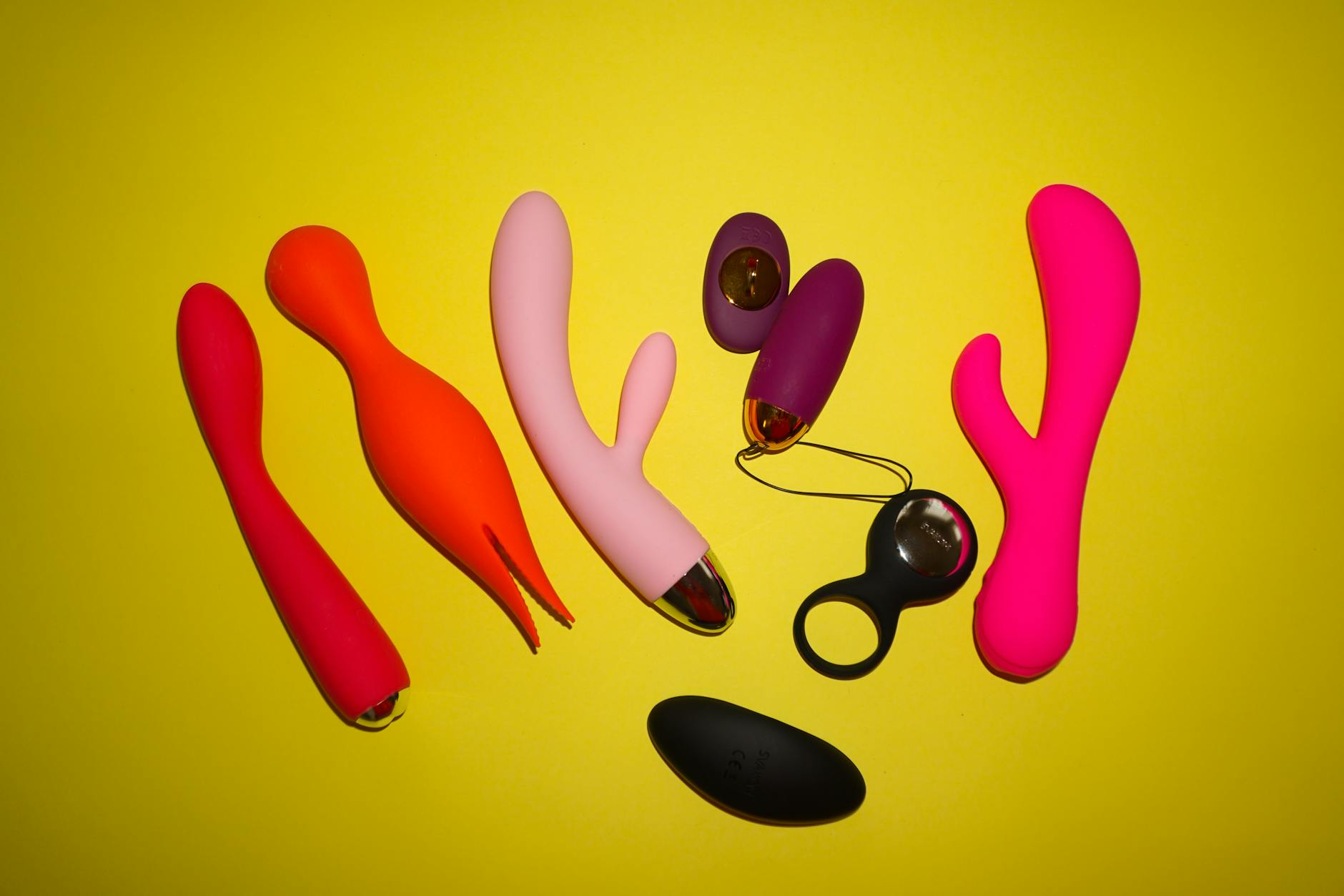 Hands holding a sleek vibrator against a purple background, symbolizing gentle reconnection with pleasure